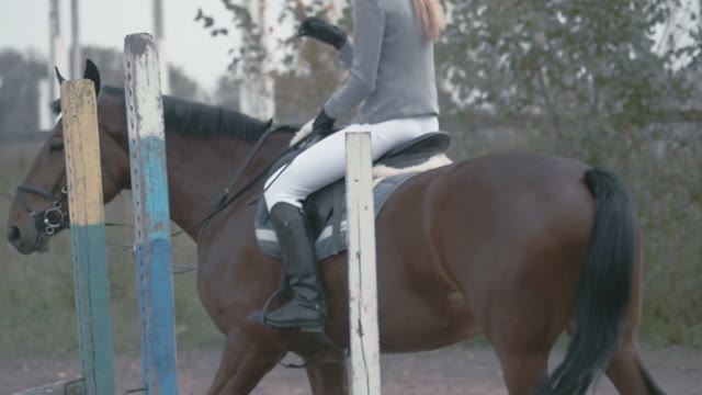 The Girl Jockey Riding On Her Horse On A Cloudy Day