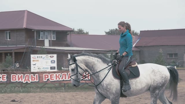 The Girl Jockey Riding On His White Horse