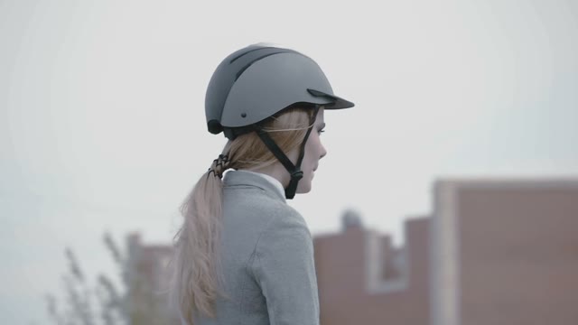 Beautiful Blond Girl Horsewoman Wearing A Helmet On A Horse