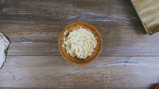 Woman's Hand Puts A Baking Sheet Close To Curd