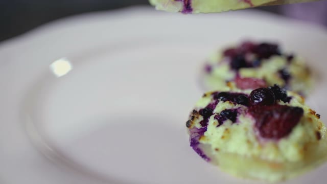 Female Hand Puts A Cake On A Plate Close-up