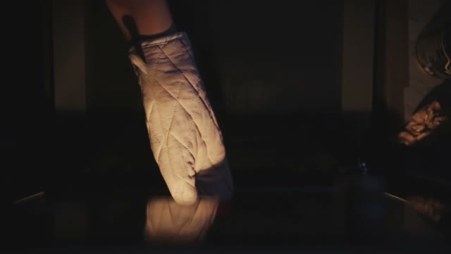 Hand Puts Forward Cakes From The Oven