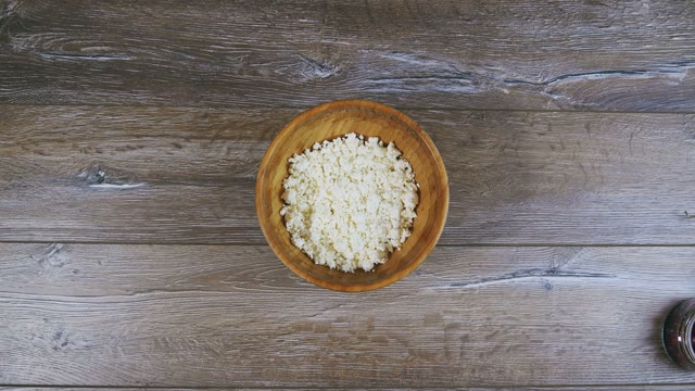 Female Hand Sprinkles Curd Of Cinnamon