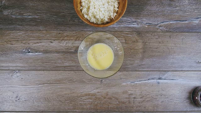 Female Hand Pushes Curds And Beaten Eggs