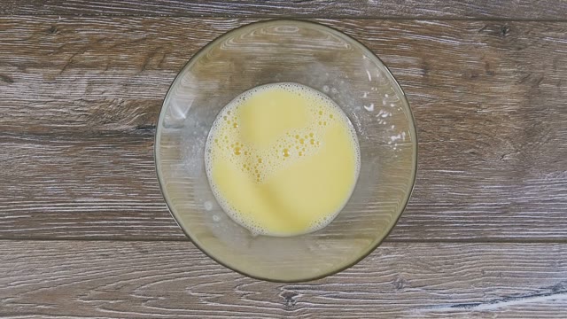 Female Hand Pushes Curds And Beaten Eggs Close-up