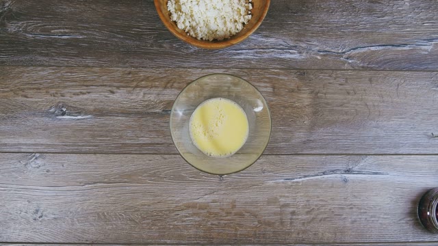 Female Hand Pushes Curds And Beaten Eggs