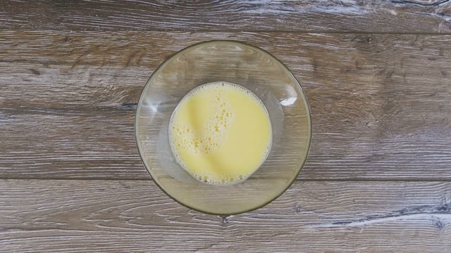 Female Hand Pushes Curds And Beaten Eggs Close-up