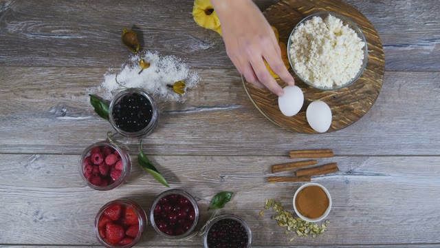 Female Hand Spinning Egg Amongst Laid Out Products