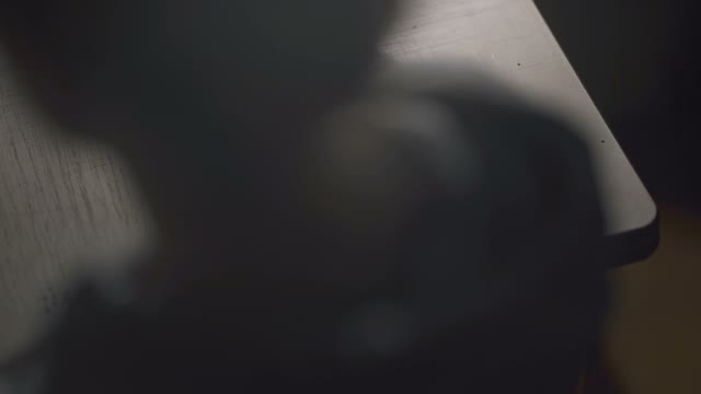 A Man Grinds Coffee In A Coffee Grinder