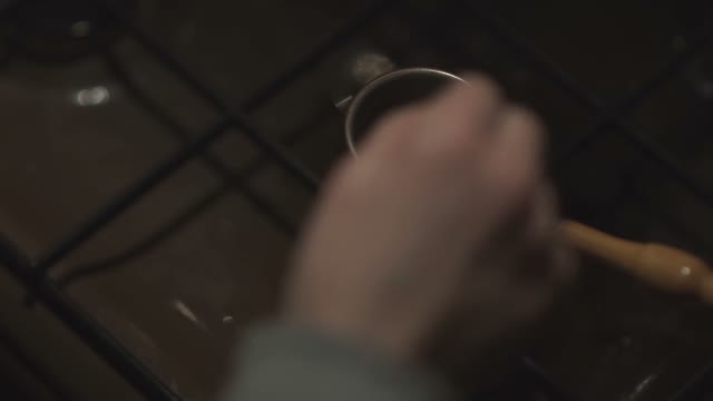Coffee In A Cezve Is Stirred With A Spoon On The Stove