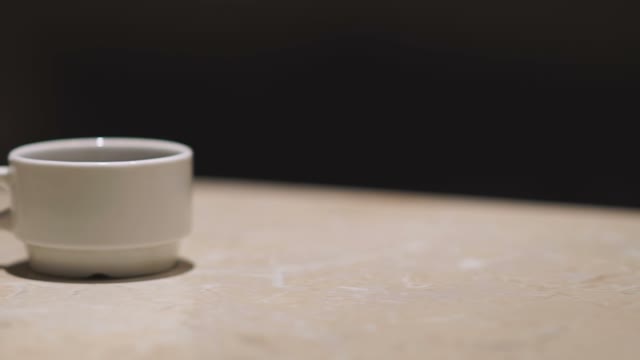 Hand Took Away From The Table A Cup Of Coffee