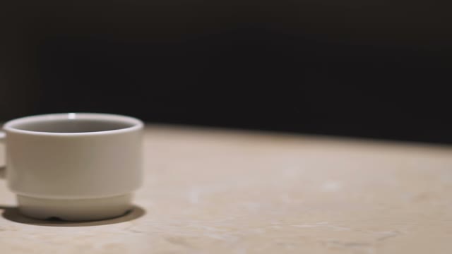Female Hand Took From The Table A Cup Of Coffee