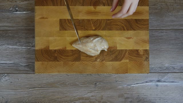 Female Hands Cut Chicken Breast