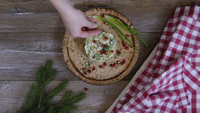 Female Hand Decorated Salad With Pomegranate