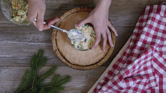 Female Hand Picks Up A Form For Salad