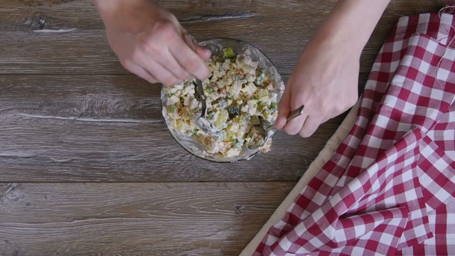 Female Hand Mixed Salad With Two Tablespoons