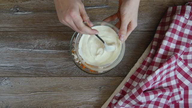 Cook Puts Sauce On Salad In A Glass Bowl