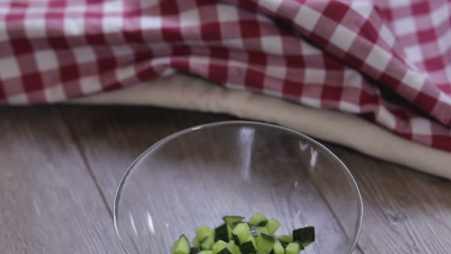 Cook Adds Cucumber To A Salad Close-up