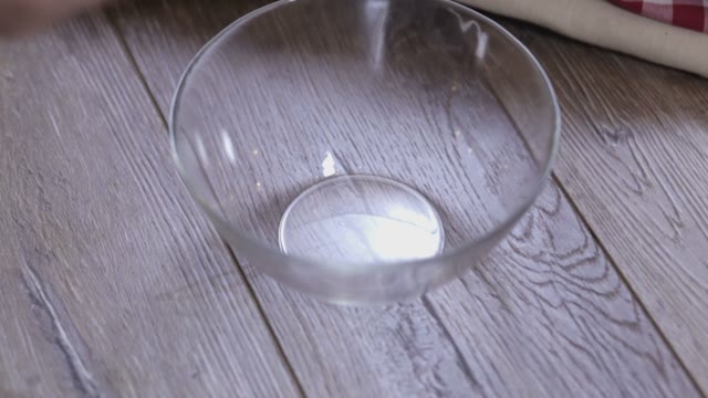 Female Hands Lay Out Pieces Of Onion In A Bowl Close-up