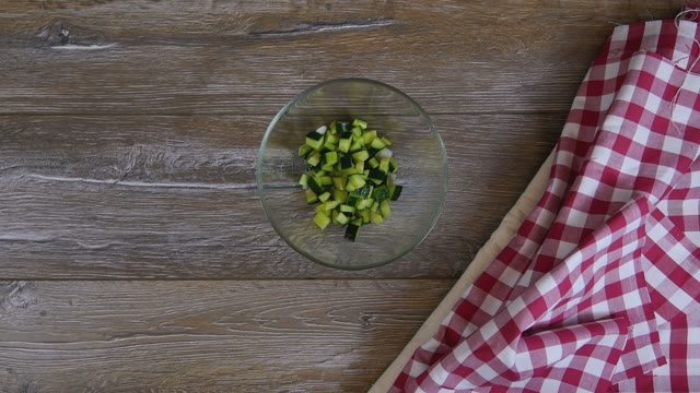 Cook Adds Cucumber To A Salad