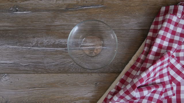 Female Hands Lay Out Pieces Of Onion In A Glass Bowl
