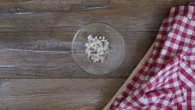 Cook Adds Onion Slices In A Glass Bowl