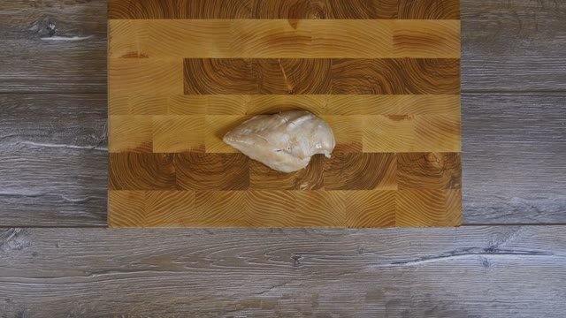 Female Hands Sliced Chicken Breast Into Pieces