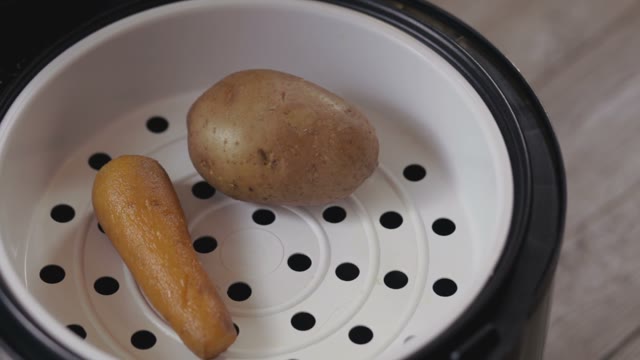 Potato And Carrot Laid Out On A Plate Close-up