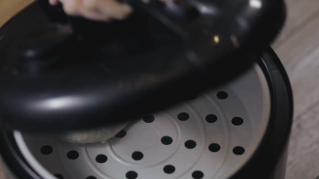 Chicken Breast Being Removed From Multicooker Close-up