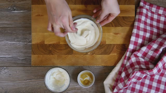 Cook Stirs The Sauce In A Glass Bowl