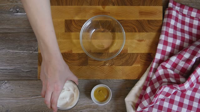Cook Puts Sour Cream In A Glass Bowl