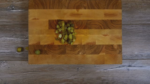 Women's Hands Removed From Wooden Board Sliced Pickled Cucumbers