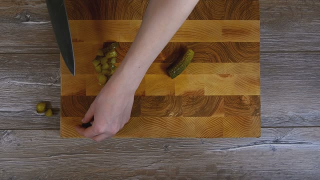 Women Hands Sliced Pickled Cucumbers