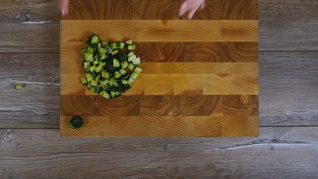 Women's Hands Removed From Wooden Board Sliced Cucumbers