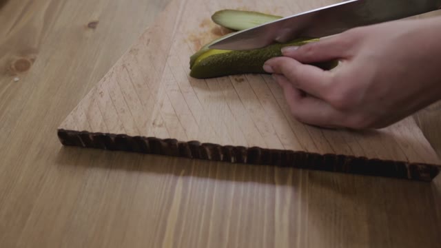 Women Hands Sliced Pickled Cucumbers Close-up