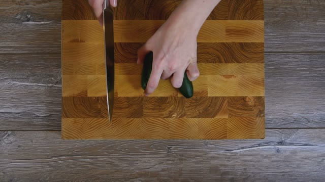 Female Hands Sliced Cucumber