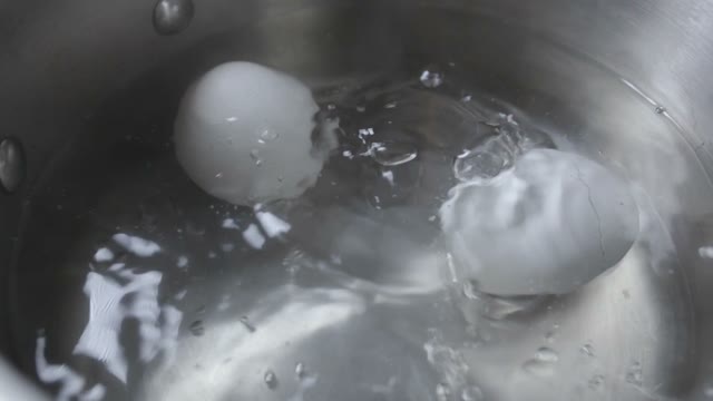 Two Eggs Are Cooked In Boiling Water Close-up