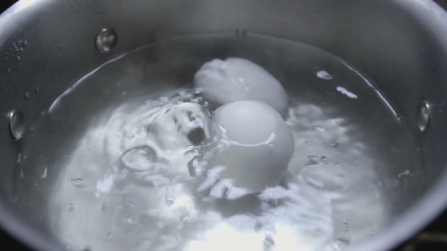 Two Eggs Are Cooked In Boiling Water Close-up