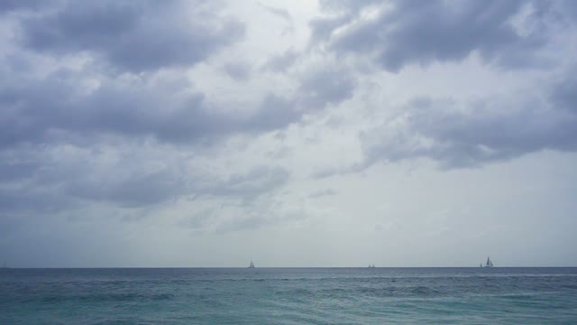 A View Of The Sailboats Floating In The Ocean