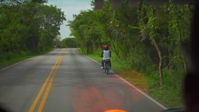 Black Guy On A Motorcycle Traveling On The Road