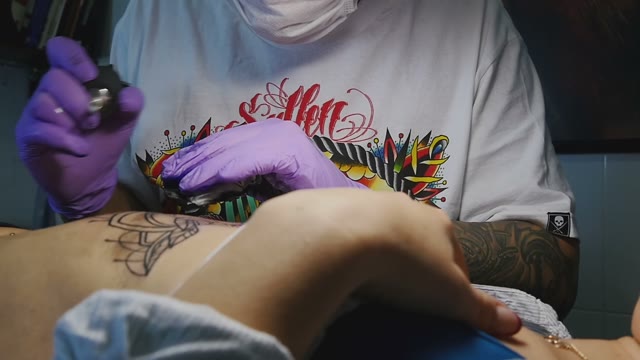 Tattoo Master Makes The Tattoo On A Woman's Body