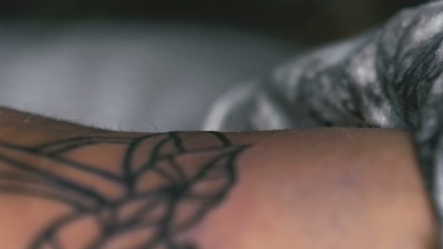 Tattoo Master Rubs The Tattoo Close-up