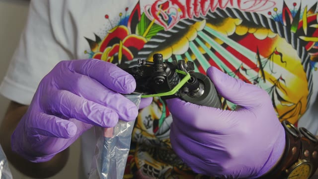 Tattoo Master Holding A Tattoo Machine Close-up