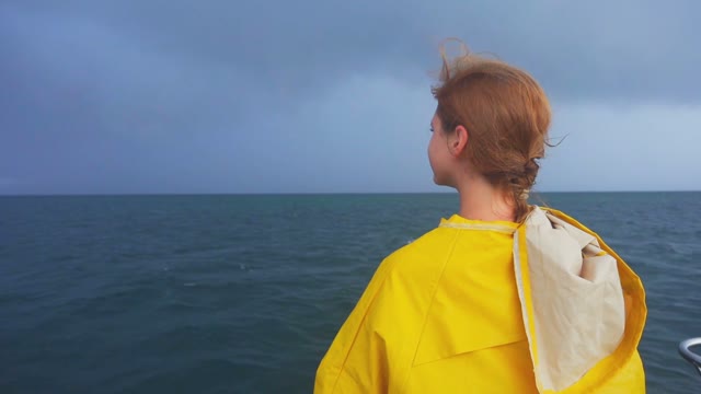 Red-haired Woman Traveler On A Boat Sailing And Admiring The Ocean