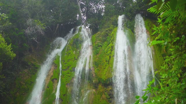 Very High Waterfall Among Green Mountains In The Rainforest