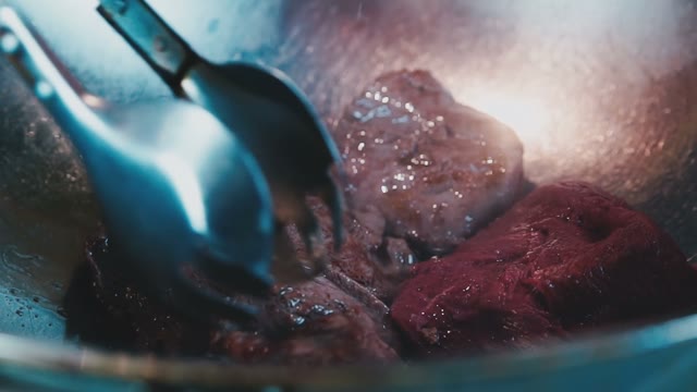 The Steak Is Fried In Iron Pots And Flipped With Tongs