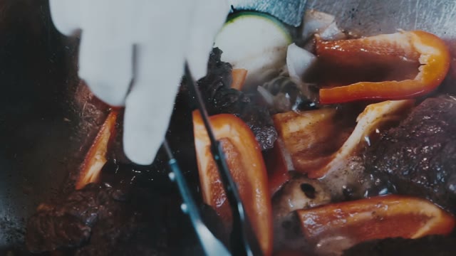 The Chef In White Gloves Preparing A Dish Of Meat And Vegetables