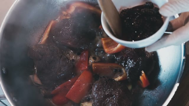 The Process Of Adding The Sauce To The Stew With Vegetables