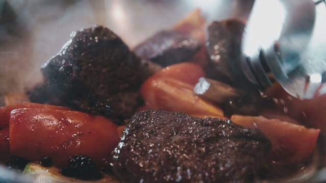 Meat With Tomatoes, Peppers, Carrots Stewed Together And Mix With Tongs