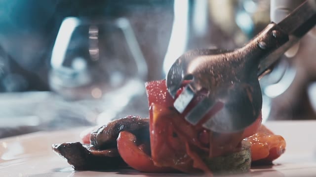 Grilled Vegetables Are Laid Out On A Plate Using Forceps